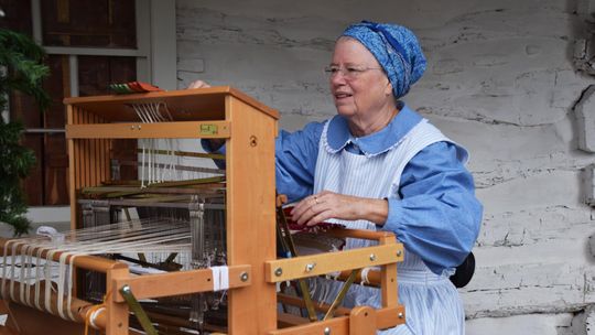 PHOTO BY LAURIE ANDERSON A weaver demonstrates her craft.