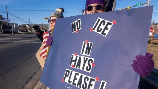 PHOTO BY DAVE WILSON About 20 protesters gathered at the junction of Highway 290 and RR12 in Dripping Springs on Jan. 10, after  the killing of Renee Good by ICE agents in Minneapolis the previous Wednesday.