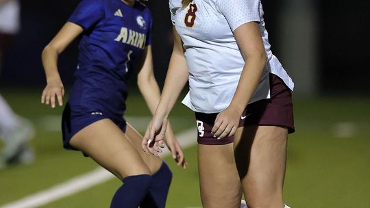 Vince Curletta Daisy Kaner (#8) keeps the ball from an Akins player.