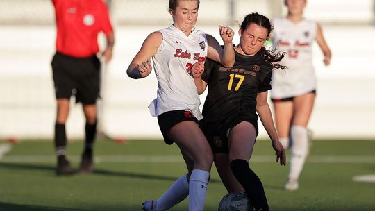 PHOTO BY VINCE CURLETTA Carson Thompson (#17) fights for the ball with a Lake Travis player