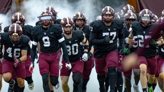 PHOTO BY CORTNI REID The Tigers run onto the field for Game 3.