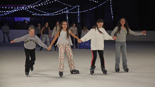PHOTO BY LAURIE ANDERSON Friends take a turn around the rink.