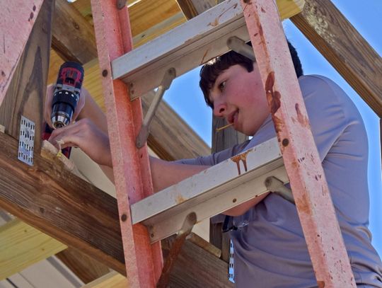 PHOTO BY LAURIE ANDERSON Hudson Debish works on the shelter.