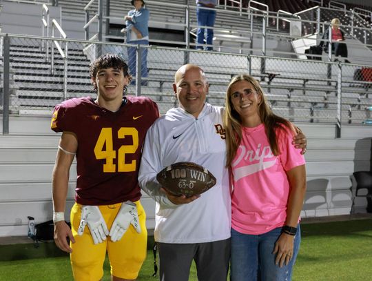 PHOTO BY CORTNI REID Coach Galen Zimmerman (with son Parker and wife Laura) is honored for his 100th win.