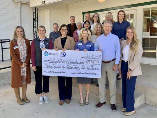 LCRA and Pedernales Electric Cooperative representatives present a $19,125 grant to the Driftwood Historical Conservation Society for improvements to the Driftwood Community Center.