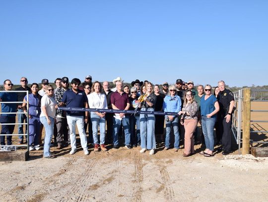 PHOTO BY LAURIE ANDERSON Dripping Springs Ranch Park manager Lily Sellers prepares to cut the ribbon at the new arena.