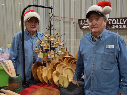 PHOTO BY LAURIE ANDERSON. Johnny and Jimmy Tolly sell their handcrafted wood items at their booth.