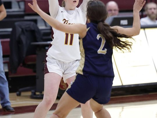 PHOTO BY VINCE CURLETTA  Ella Beatty (#11) looks for an open player to pass to in Friday night's game against Akins.
