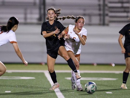 PHOTO BY VINCE CURLETTA Lily Ruff (#24) protects the ball from a Westwood player in Thursday's playoff game