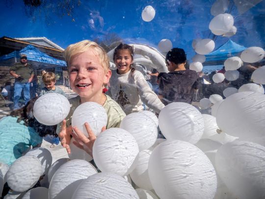 PHOTO BY DAVE WILSON Kids play in the inflatable snow globe during Christmas on Mercer.