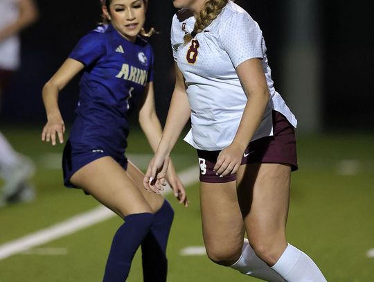 Vince Curletta Daisy Kaner (#8) keeps the ball from an Akins player.