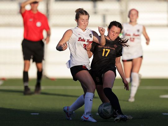 PHOTO BY VINCE CURLETTA Carson Thompson (#17) fights for the ball with a Lake Travis player