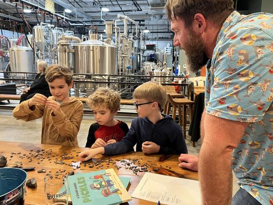 PHOTO BY LAURIE ANDERSON Matt Marchant, author of “A Shark Named Pickles,” identifies different objects, including shark teeth, for his young audience.