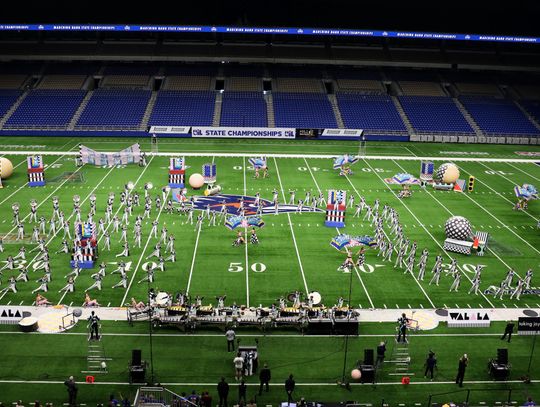 PHOTO BY CARYN PACELLI The Dripping Springs Tiger Band fills the Alamodome field with music and color for the UIL State Marching Contest.