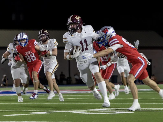 PHOTO BY CORTNI REID Colton Hanson carries the ball for the Tigers.