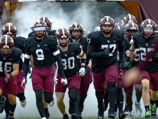PHOTO BY CORTNI REID The Tigers run onto the field for Game 3.