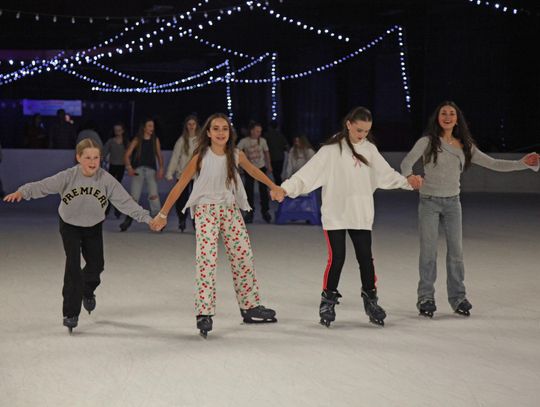PHOTO BY LAURIE ANDERSON Friends take a turn around the rink.