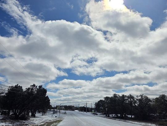 PHOTO BY KRISTI HAYNES  Ice covers Ranch Road 12 near the intersection of Roger Hanks.