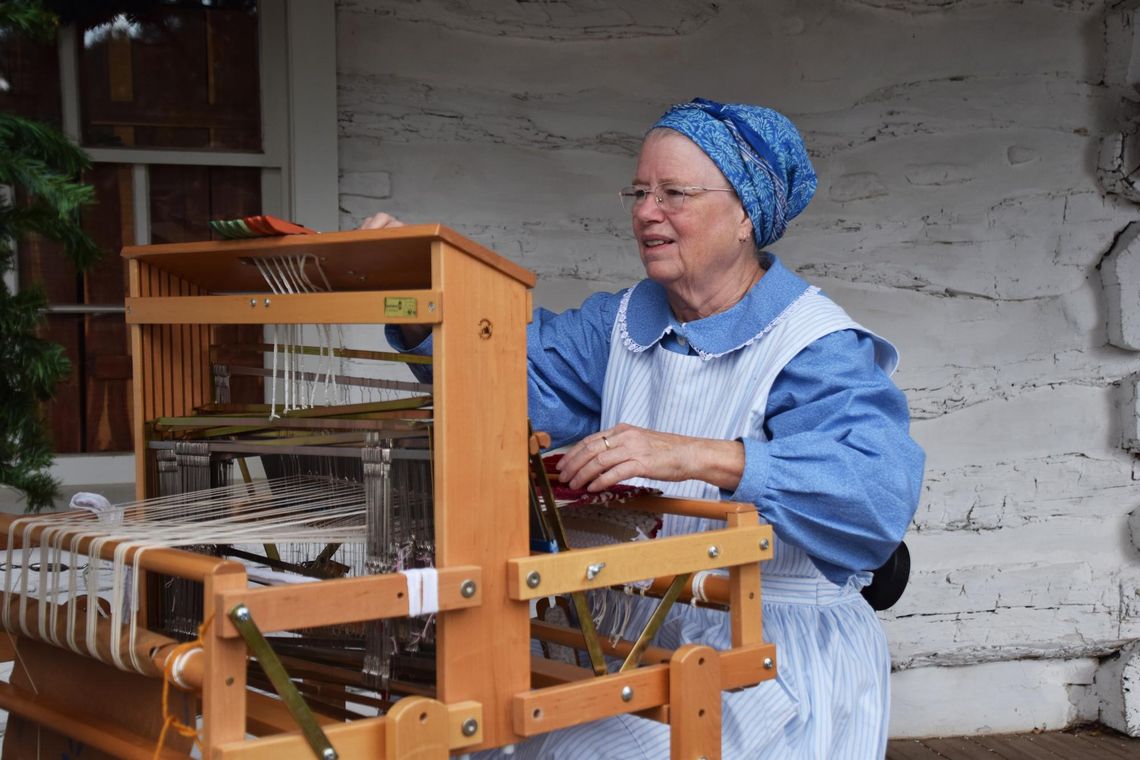 A Christmas Classic PHOTO BY LAURIE ANDERSON A weaver demonstrates her craft.