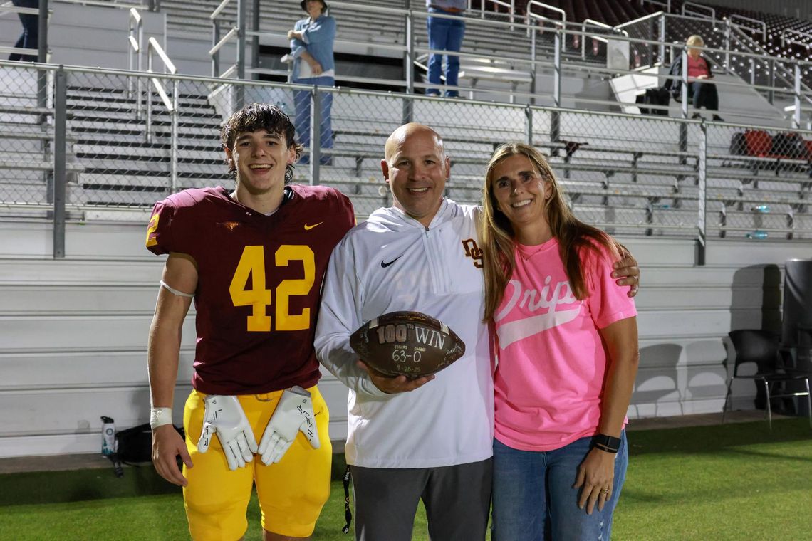 Coach Zimmerman notches 100th victory in Del Valle win PHOTO BY CORTNI REID Coach Galen Zimmerman (with son Parker and wife Laura) is honored for his 100th win.
