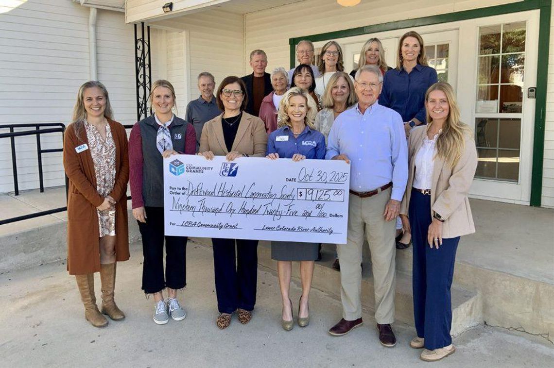 LCRA and Pedernales Electric Cooperative representatives present a $19,125 grant to the Driftwood Historical Conservation Society for improvements to the Driftwood Community Center.