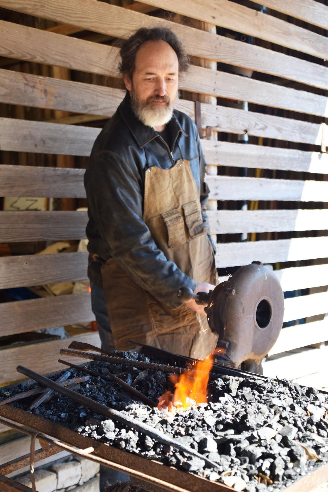 PHOTO BY LAURIE ANDERSON Matt the Blacksmith gets the fire hot in his forge.