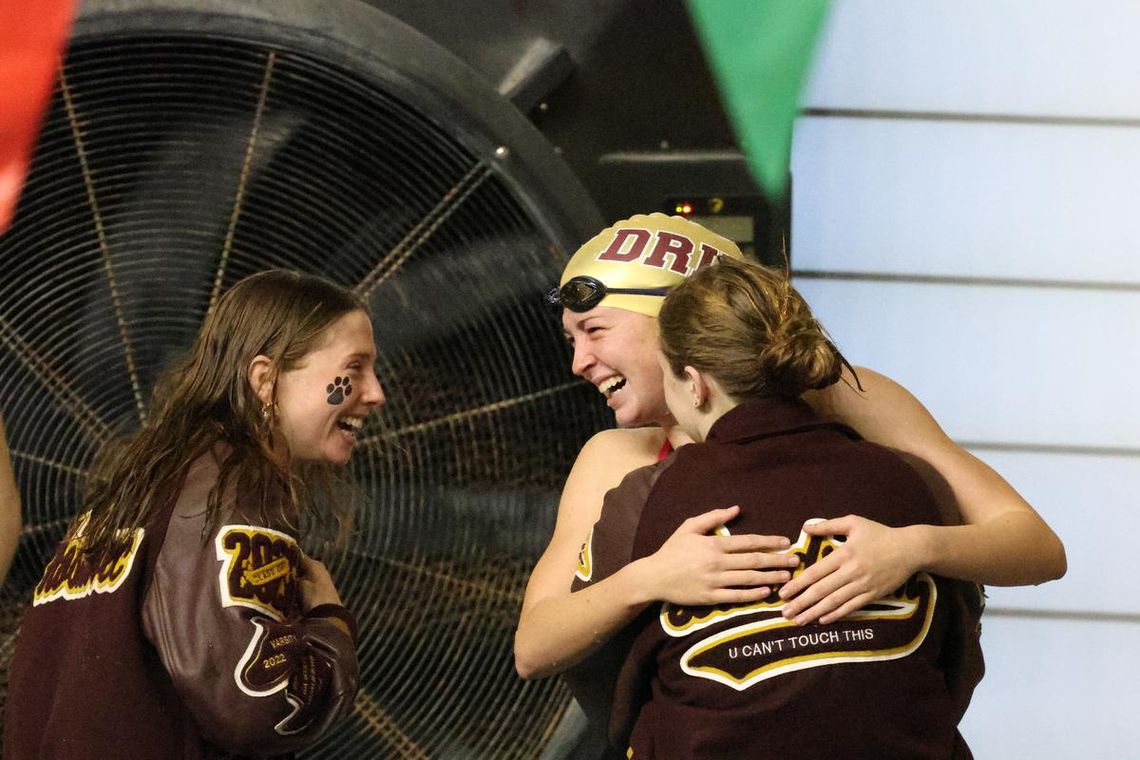 PHOTO BY JEFF MAY Laurel Hoskovec (senior) and Lexi Landrum (sophomore) celebrate with Abigail Owens (senior) after she swam a personal best time at UIL Regionals in the 100 Breaststroke.