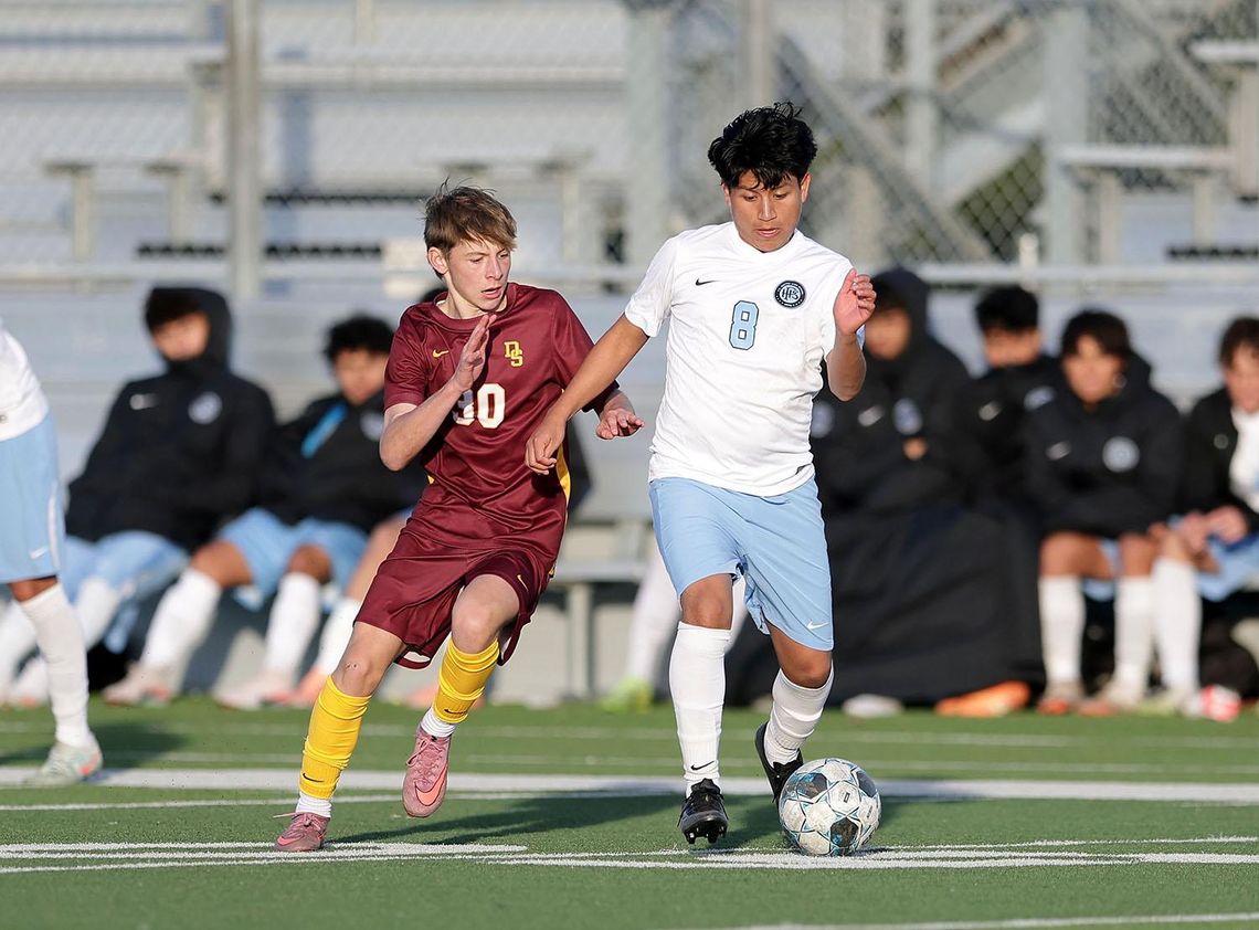 PHOTO BY VINCE CURLETTA Lane Hahnel (#30) tries to get past a Katy player in Saturday's tournament game. The final score was 4-2, with Dripping Springs taking the loss.