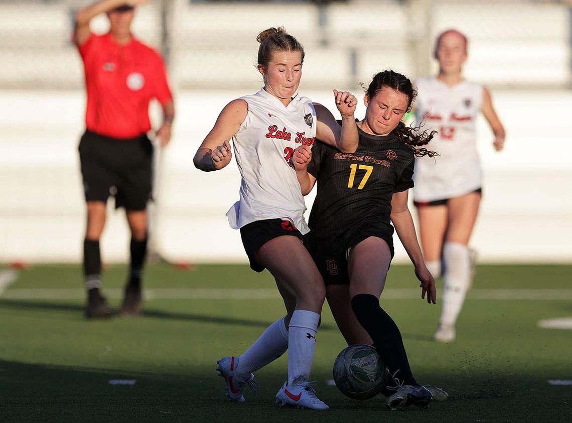 PHOTO BY VINCE CURLETTA Carson Thompson (#17) fights for the ball with a Lake Travis player