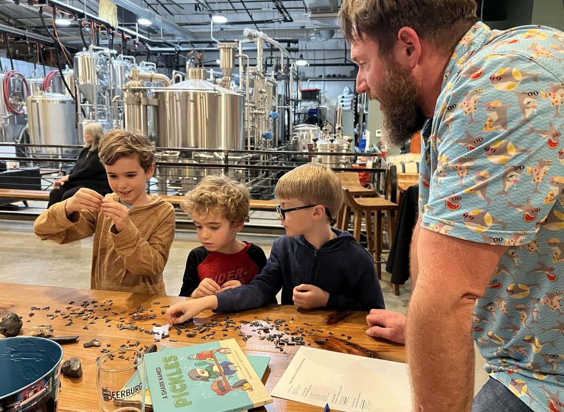 Story Maker Fair highlights young writers, local authors PHOTO BY LAURIE ANDERSON Matt Marchant, author of “A Shark Named Pickles,” identifies different objects, including shark teeth, for his young audience.