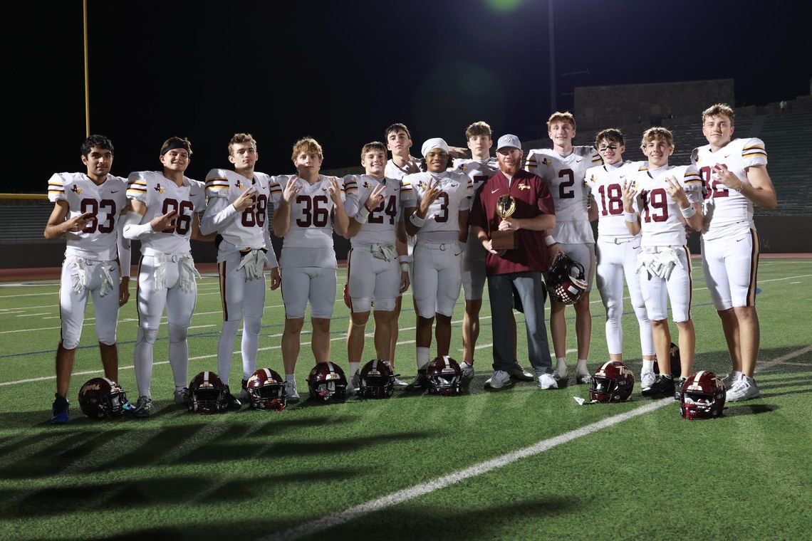 Tigers blast Harlan 52-28 PHOTO BY CORTNI REID Coach Ethan Noel and the Tiger receivers celebrate with their golden football.