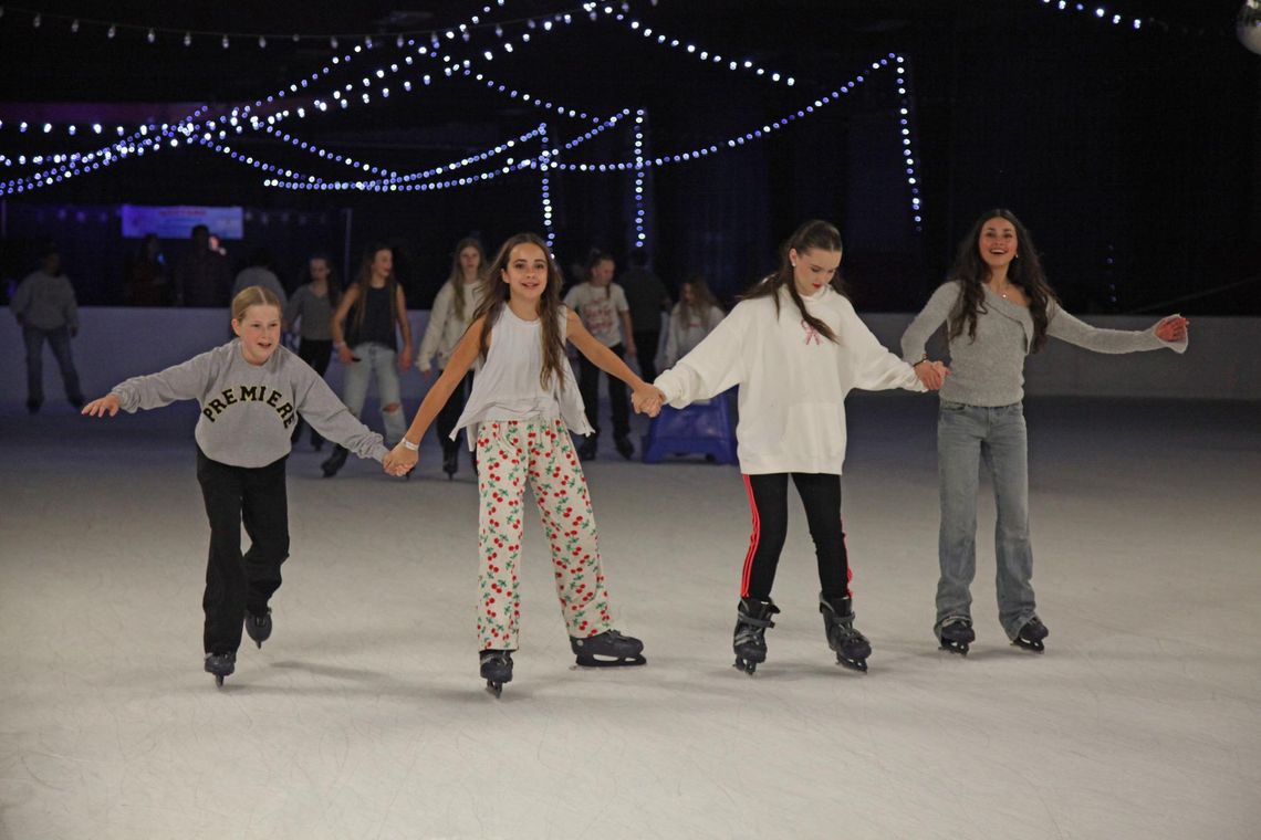 PHOTO BY LAURIE ANDERSON Friends take a turn around the rink.