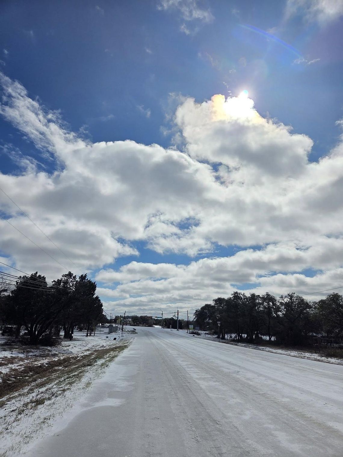 PHOTO BY KRISTI HAYNES  Ice covers Ranch Road 12 near the intersection of Roger Hanks.