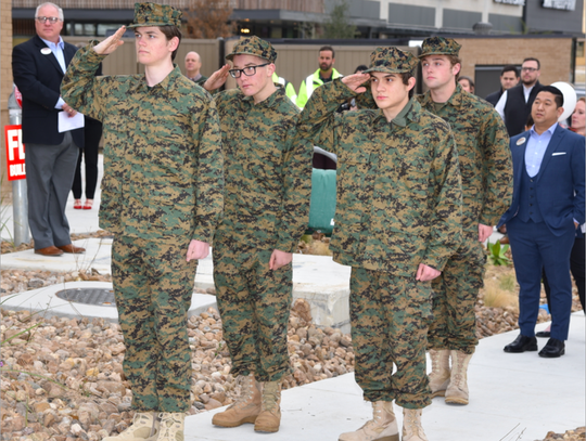 DSHS ROTC Club salute the U.S. Flag.