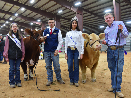 From left to right: Duchess Rebekah McDaniel, Ambassador Ty Dahlstrom holding his steer “Shorty,” Queen Mia Cariaga, and Cade Oldham (a DSHS senior) holds his steer called “Butterball.”