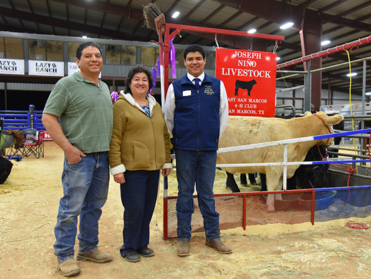 : Joseph Nino from San Marcos with his parents, Alfredo and Leticia Nino, in front of their show cows.