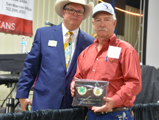 Jeff Dodd, President of the Hays County Livestock Show, presents the Herdiman Award for the Lamb Division to Eddie Ronshansen of Wimberley. CENTURY NEWS PHOTO BY JOHN PACHECO