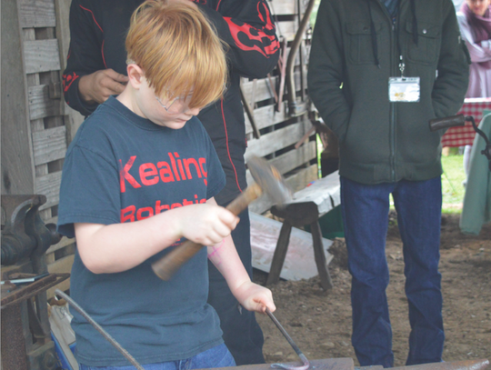 Owen Putnam tried his skill as a blacksmith.