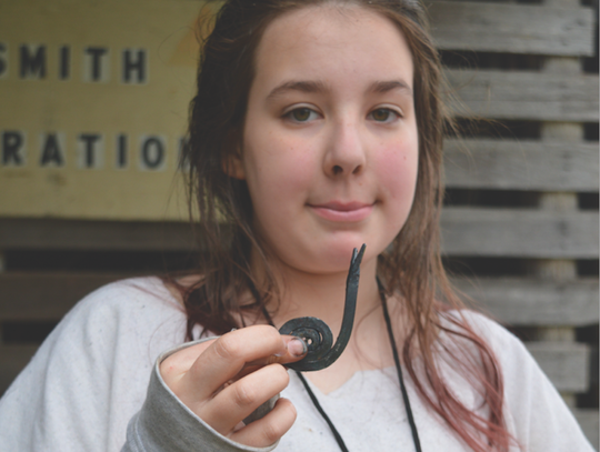 Robyn Facioe shows the snail decoration she hammered out.