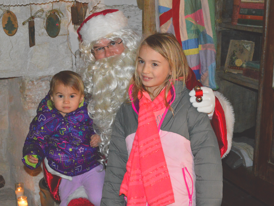 Santa was taking wish lists from Evangeline and Samantha Sellers.