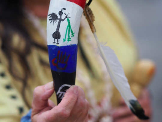 Julie Land Bridges holds a rattle that was made in the manner of native American Indians. A hollowed-out cow horn filled with rattlesnake tails.