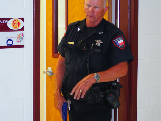 Pct. 4 Deputy Chick Williams secures a school room and hallway for EMS as part of an integrated response exercise.