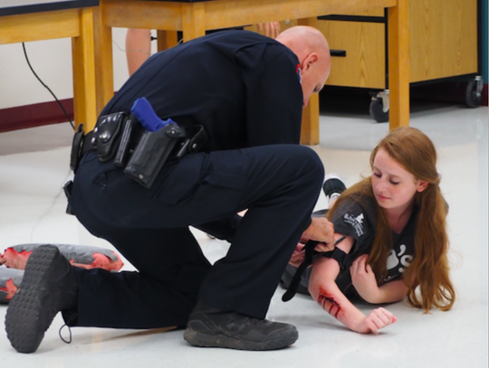 Pct. 4 Constable Jimmy Zuehlke attends a simulated wounded Emma Satine.