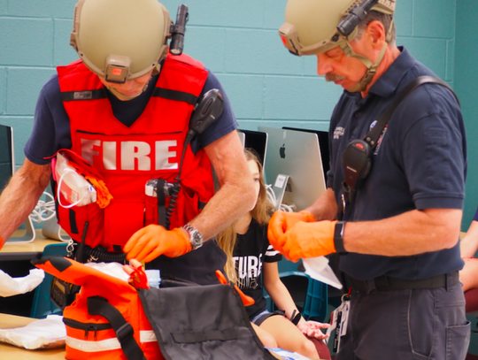 Members of North Hays Fire/Rescue prepare to treat simulated injuries.