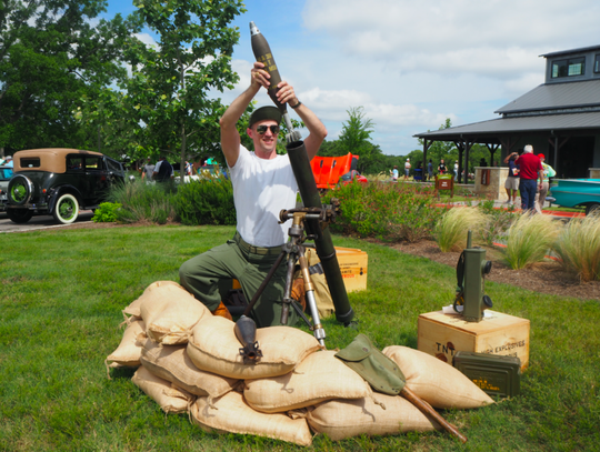 Bisett plays at loading his 81mm mortar tube. “This mortar tube was the largest made for the infantry in World War 2,” Bisett said.