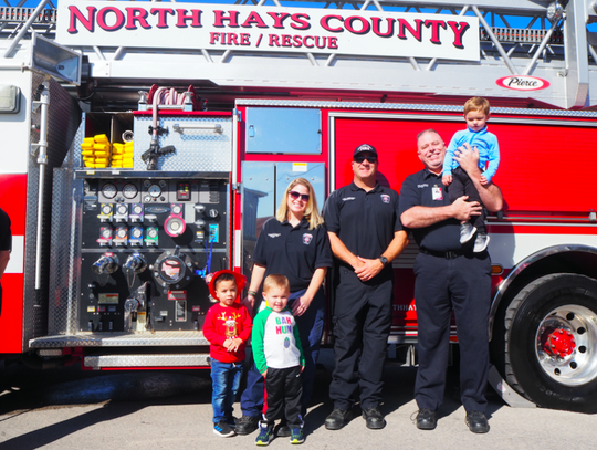 North Hays Country Fire/Rescue Firefighters Rebekah Swartz, Tony Cimando, and Dean Rudolph gave kids a tour of the new ladder truck.