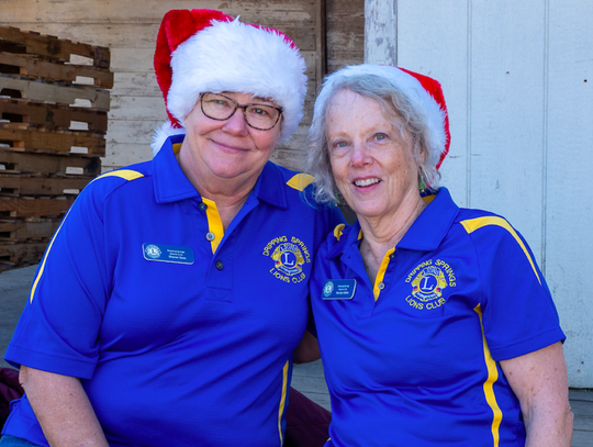 Sharon Gross and Marilyn Miller from Dripping Springs Lions Club get the seasonal spirit during Dripping Springs "Christmas on Mercer", Saturday, December 7th, 2019.