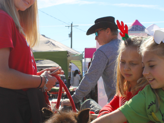 Claire Celements and Addison Griffin meet one of the ponies from Red Arena and helper Kendall