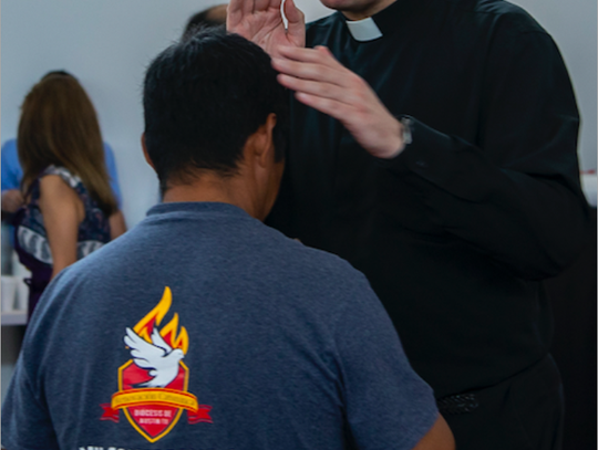 Fr. Garza blesses a parishioner.