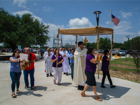 Fr. Garza leads Corpus Christi Father Charlie leads the procession at St Martin de Porres.